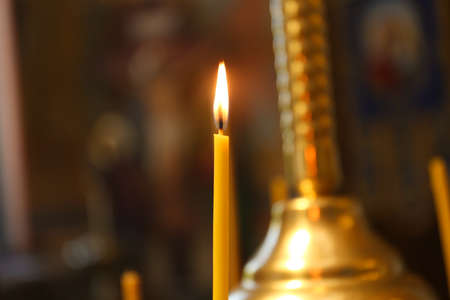 One burning candle in church, closeup viewの写真素材