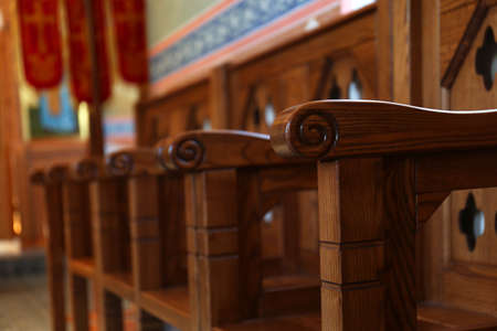 Empty wooden bench in church, closeup. Space for textの写真素材