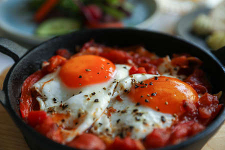 Tasty Shakshouka served in pan on table, closeupの写真素材