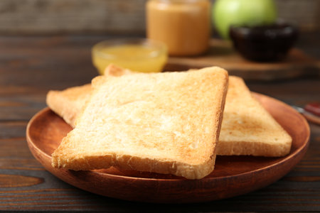 Crispy toasts on wooden table, closeup. Delicious breakfastの写真素材
