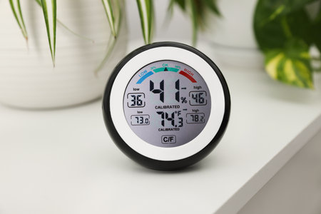 Digital hygrometer with thermometer on white table, closeupの写真素材