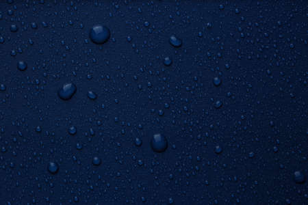 Many water drops on bright blue background