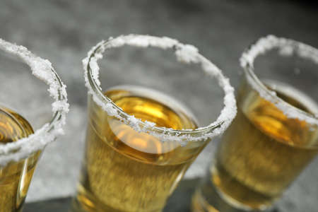 Mexican Tequila shots with salt on gray table, closeupの写真素材
