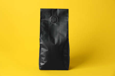 One blank foil package on yellow backgroundの写真素材