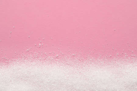 Granulated sugar on pink background, top view. Space for textの写真素材