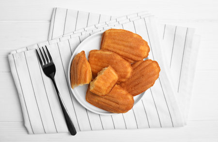 Delicious madeleine cakes on white wooden table, flat layの素材 [FY310189798547]