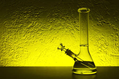 Glass bong on table, space for text. smoking deviceの写真素材