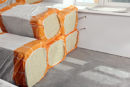 Packages of thermal insulation material in room. Space for text