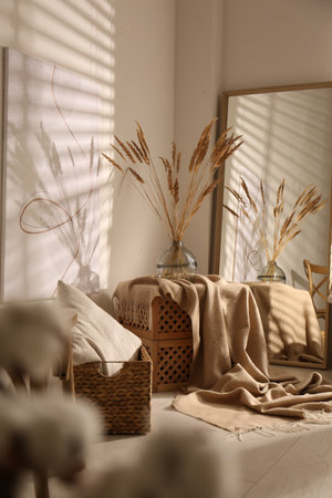 Vase with decorative dried plants and painting in stylish room interiorの写真素材