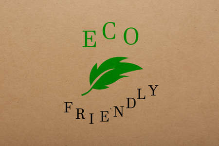 Phrase Eco Friendly written on cardboard, top viewの写真素材
