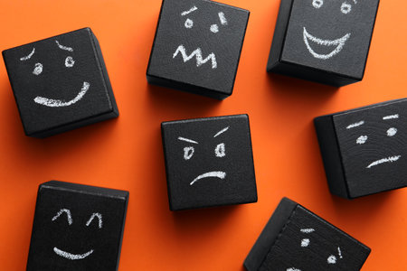 Many cubes with different emotions on orange background, flat lay. Emotional managementの写真素材