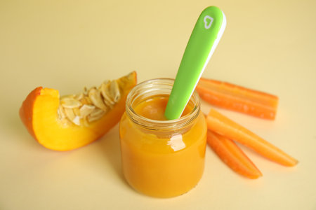 Healthy baby food and ingredients on beige backgroundの写真素材