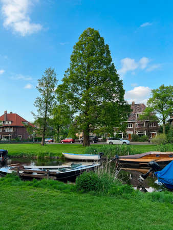 Beautiful city canal with moored boats on spring dayの写真素材