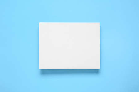 Blank canvas on light blue background, top view. space for design