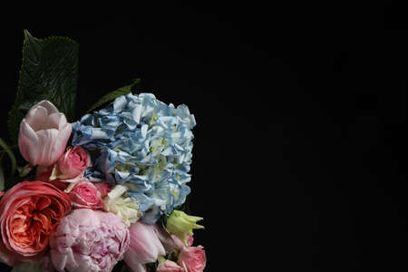 Beautiful fresh flowers on dark background, space for textの写真素材