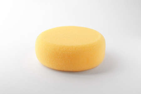 Yellow sponge for clay modeling on white backgroundの写真素材