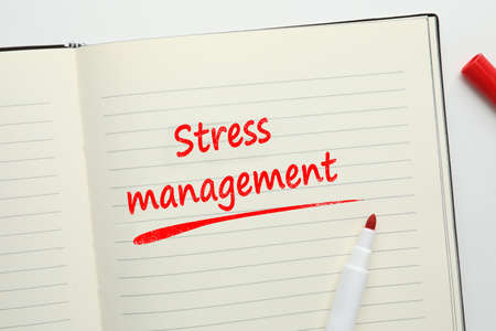 Notebook with text Stress Management and red felt tip pen on white background, top viewの写真素材