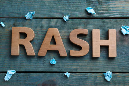 Word Rash made of wooden letters and crumpled paper on light blue table, flat layの写真素材