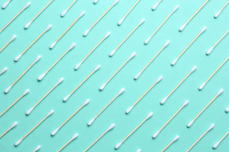 Many cotton buds on turquoise background, flat layの写真素材