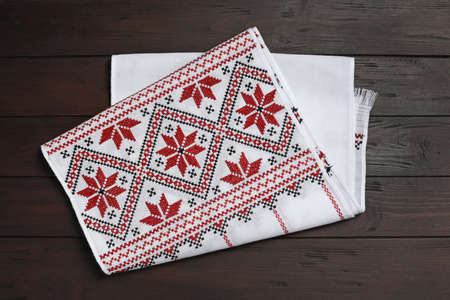 Beautiful rushnyk on wooden table, top view. Ukrainian national embroideryの写真素材