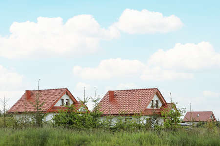Modern buildings with red roofs outdoors on spring dayの写真素材
