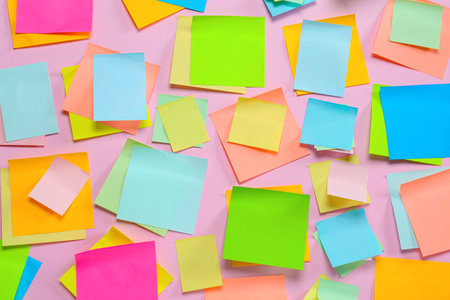 Blank colorful sticky notes on pink background, flat lay