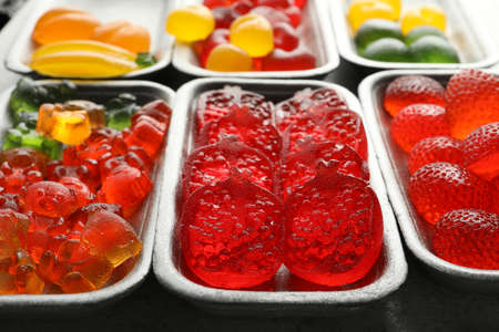 Different delicious gummy candies on gray table, closeupの写真素材