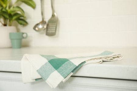 Clean towel on white countertop in kitchenの写真素材