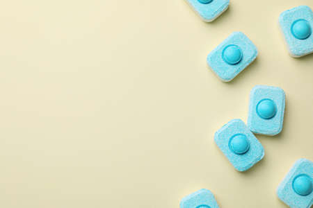 Water softener tablets on beige background, flat lay. Space for textの写真素材