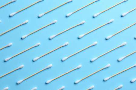 Many cotton buds on light blue background, flat layの写真素材