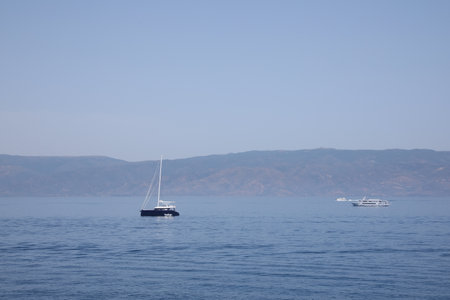 Beautiful seascape with boats and distant shoreの写真素材