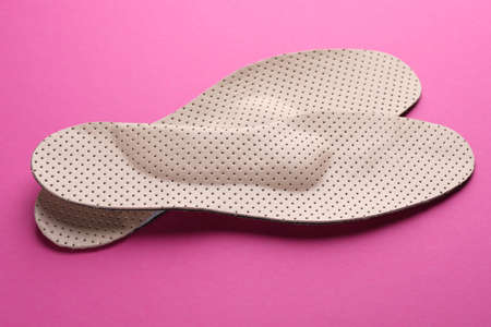 Orthopedic insoles on pink background, closeup. foot careの写真素材