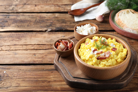 Tasty banosh served with brynza and pork cracklings on wooden table, space for text. Traditional Ukrainian dishの写真素材