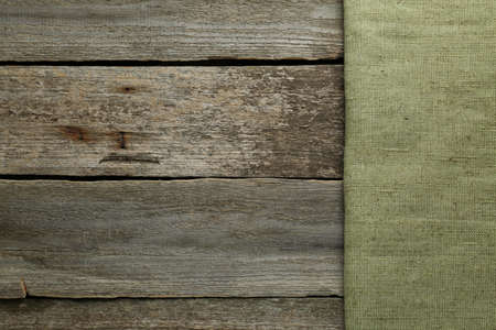Natural burlap fabric on wooden table, top view. Space for textの写真素材