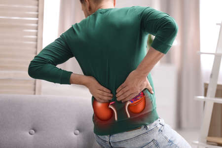 Man suffering from kidney pain at home, closeup