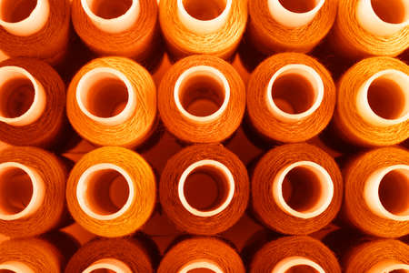 Set of orange sewing threads as background, top viewの写真素材