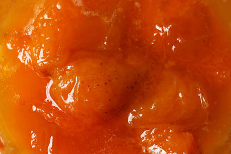 Delicious apricot jam as background, closeup viewの写真素材