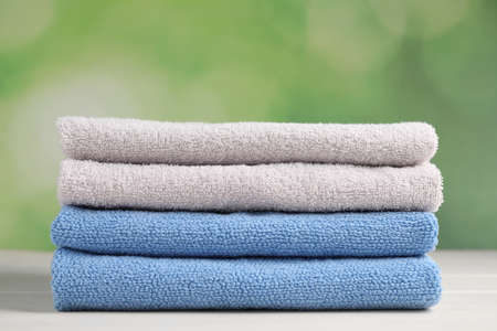 Soft folded towels on white wooden tableの写真素材