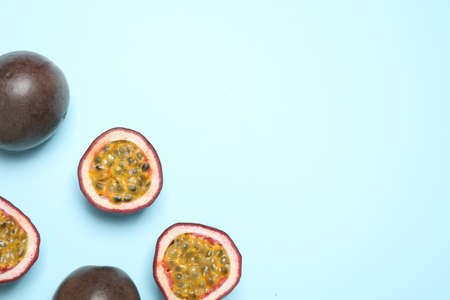 Fresh ripe passion fruits (maracuyas) on light background, flat lay. Space for textの写真素材