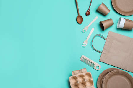Different eco items on turquoise background, flat lay with space for text. Recycling conceptの写真素材