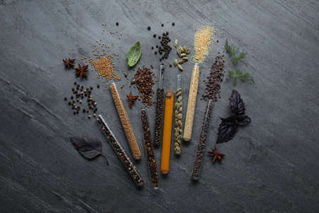 Flat lay composition with different spices and herbs on black slate tableの写真素材