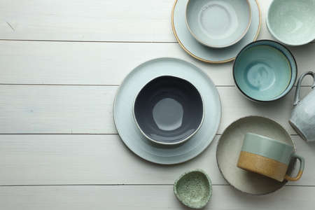 Stylish empty dishware on white wooden table, flat lay. Space for textの写真素材