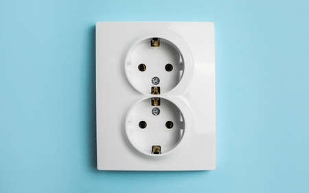 Double power socket on light blue wall. electrical supplyの写真素材