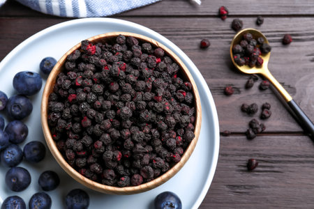 Freeze dried and fresh blueberries on wooden table, flat layの写真素材