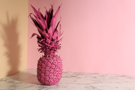 Pink pineapple on color background, space for text. creative conceptの写真素材