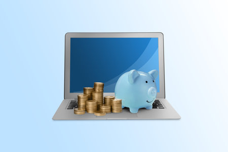 Piggy bank with different height coin stacks and laptop on light blue background. online bankingの写真素材