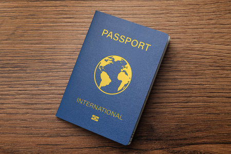 Blue international passport on wooden table, top viewの写真素材