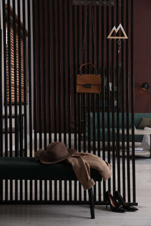 Key holder on black wooden folding screen in roomの写真素材