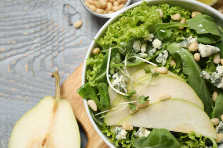 Fresh salad with pear on gray wooden table, closeupの写真素材
