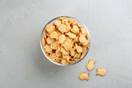 Delicious goldfish crackers in bowl on gray tableの写真素材